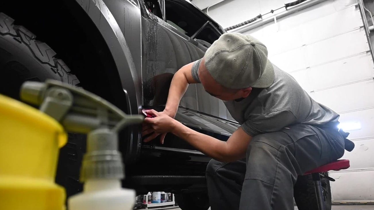 Kendall Accessories Employee Wrapping Ford Raptor with Custom Wrap